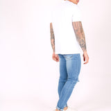 Logan Skinny Stretch Jeans In Light Stonewash With Ripped Knee